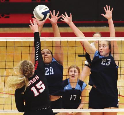 Southwest’s Jazmine Walz and Bailey Truksa rise to block a McCook attacker Saturday.