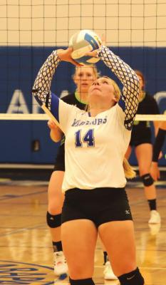 Arapahoe’s Gentry Warner backsets a teammate at a home triangular last week.