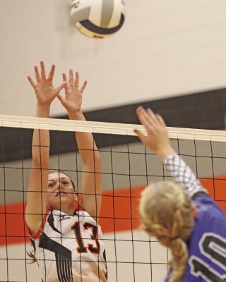 Cambridge’s Annabelle Taylor rises for a block.