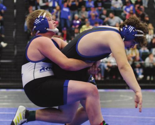The Warriors’ Noah Williams works a mat return during a match against Ravenna.