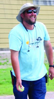 A Bartley Days volunteer demonstrates how to do the water balloon toss.