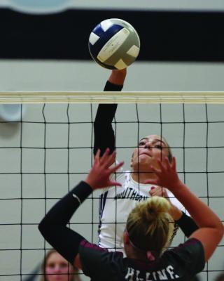 Southern Valley’s Adi Hunt swats an attack.
