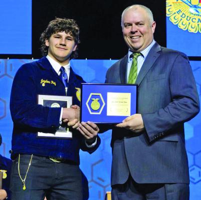 Cambridge senior Jyaden Ruf receives the Nebraska FFA State Star in Ag Production Friday at the State FFA Convention.