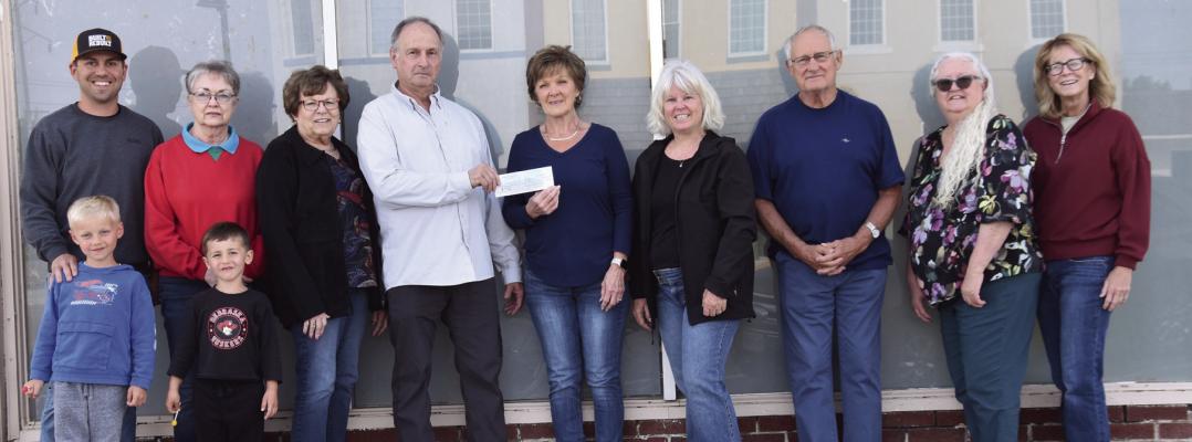 Grant money was presented to the Museum board members last week. (l-r) Adam Snyder and his sons Jack and Sam, Sherry Cacy, Cathy Schievelbein, John Tangeman, Jamie Person, Bev Osiecki, Wayne Lammel, Lori Moore and Christine Urbom.