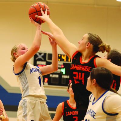 Arapahoe’s Emma Strand pulls up for a jumper in the lane against the challenge of Cambridge’s Brylyn Springer.