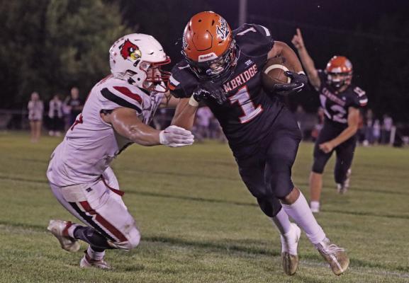 Cambridge’s Dierks Sayer intercepts a pass and returns it inside the Alma 20.
