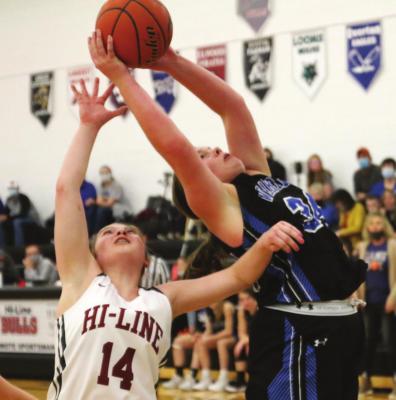 The Warriors’ Hope Koller snatches a rebound over the Bulls’ Zoey Evans.
