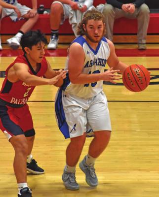 Arapahoe’s Cord Frink dribbles in the half court.