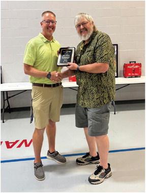 Board president Derek Bantam presenting the Curtis Citizen of the Year Award to Kevin Brown.