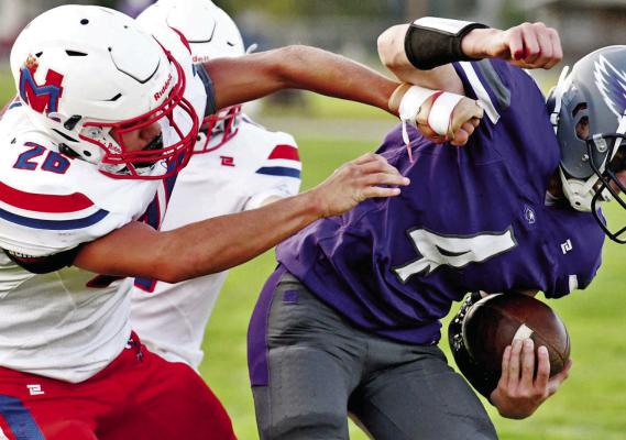 The Raiders’ Lucas Einspahr tries to bring down a Garden County runner.