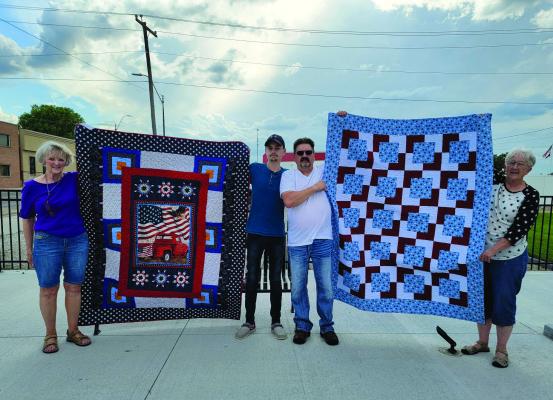 Veterans Thomas Schwarz and Shane Schwarz, both of Elwood, were presented Quilts of Honor, Tuesday, June 24. The quilts were presented by Prairie Quilt Guild members Marty Kleppinger and Kathy Beck. Thomas (second from left) is an Air Force veteran serving in England 2017-2023 and his dad, Shane served in the Army 1986-2014 with tours in Iraq. Prairie Quilt Guild is made up of members from the Holdrege area. The women have presented over 750 Quilts of Honor quilts to area veterans since 2017.
