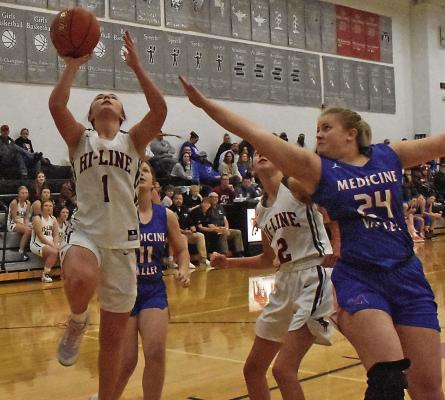 Hi-Line’s Ellaray Koch tries a layup against a shot challenge from Medicine Valley’s Brooke Kotschwar.