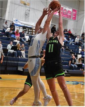 The Wolves’ Keenan Richards and Roughriders’ Houston Billeter battle for a rebound.