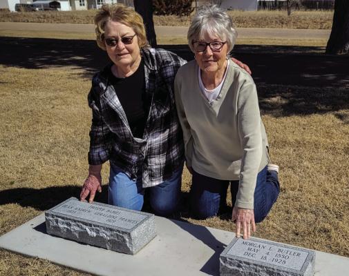 Pearl Hinz and Virginia Roberts pose with grave markers recently donated and set at Fairview Cemetery in Cambridge.