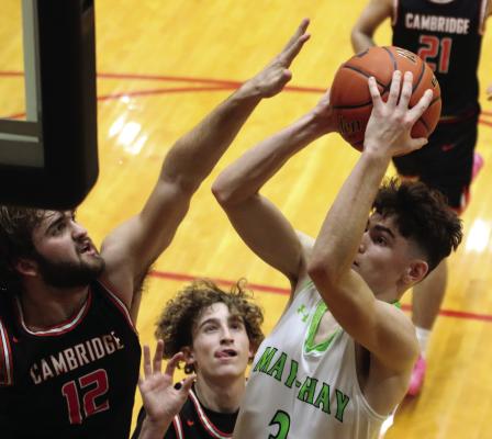 Cambridge’s Krayton Ruggles challenges the shot of MHC’s Charlie Callis.
