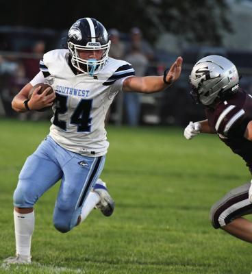 Southwest’s Conner Weaver stiff-arms a Silver Lake defender.