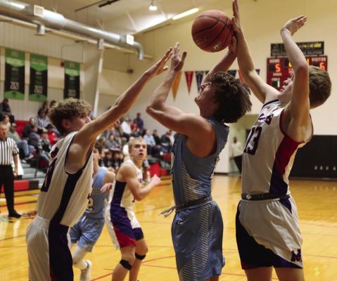Southwest’s Trenton Williams goes up against two Medicine Valley defenders.