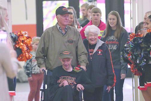For Cambridge’s Homecoming parade Friday, lifelong Trojans fan Cordy Kester served as the Grand Marshal. He is pictured with his parents, Ed and Marilyn Kester, who would crown the Cambridge Homecoming Royalty that evening.