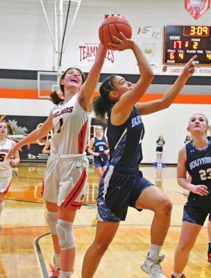 Cambrigde’s Paige Klumpe rejects a layup from Southwest’s Asia Gallegos at Thursday’s subdistrict final.