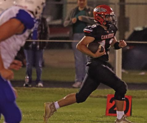 Cambridge’s Sean Polly returns an interception, one of two on the night for the soon-to-be-named Homecoming King.