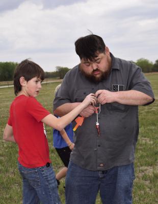Aiden Steinhour and his father Wayland prepare the rocket before launching.