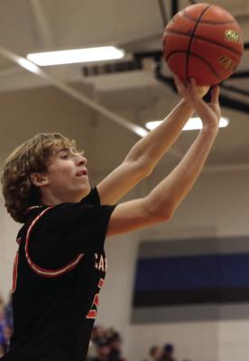 Cambridge’s Hodge Raburn launches a three from the corner.