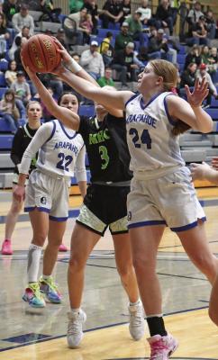 Arapahoe’s Clara Hilker rips a reboud away during the Warriors’ third-place victory over MHC Saturday.