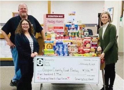 Security First Bank staff presenting the Gosper County Food Pantry with a $500 check along with food and personal care item donations.