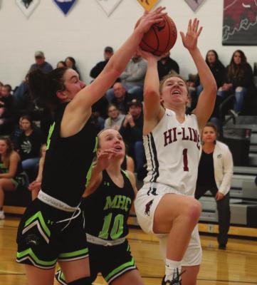 The Bulls’ Whitney Dickau challanges a MHC defender in the paint.