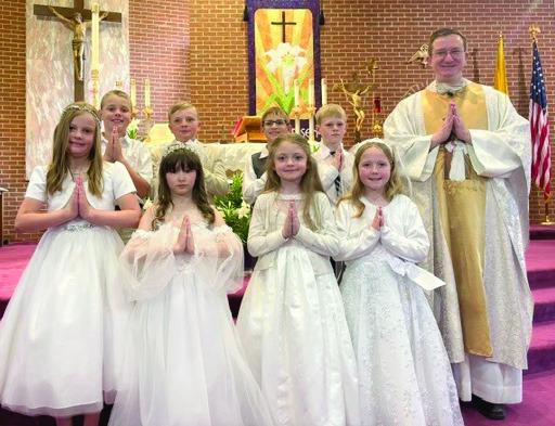 Sunday, April 12th First Communion was celebrated at St. John the Baptist Church in Cambridge. Pictured are: Back row, L-R: Emmett Swisher, Jerrett Sayer, Aiden Harding, Henry Klinkebiel, Rev. Kenneth J. Wehrs. Front Row, L-R: Kylie Ruf, Nora Schulte, Blakely Gross, Koral Biedeck