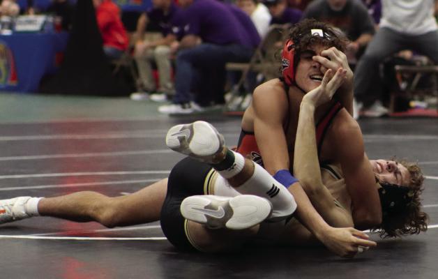 THE PAIN OF VICTORY: Cambridge’s Dierks Sayer gets a face-full of push back during a victory over Aquinas second-ranked wrestler Saturday at the State Dual Tournament. Cambridge fell to Aquinas, but bounced back with wins over Burwell and Thayer Central to finish fifth.