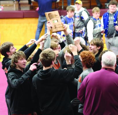 The Cambridge wrestling team celebrates its first Republican Plains Activities Conference Wrestling Title.