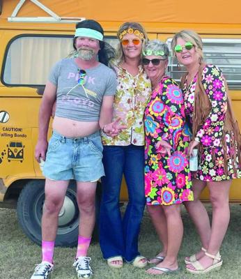 theme. They had a fish fry with around 74 people coming to help celebrate. Most of the guests came in hippy attire. Pictured above are Eric Meyers, and Angela Dawson. Amy Watson, Kate Meyers