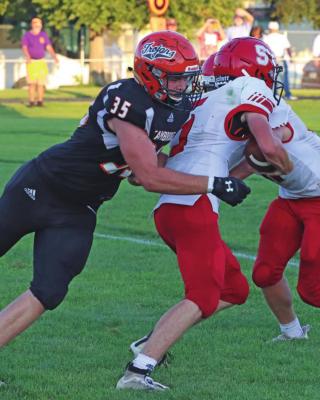 Cambridge’s Julien Grindle sacks the Sutherland quarterback Friday night.