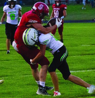 Maywood-Hayes Center’s Sawyer Dibbern takes down a Sutherland receiver.