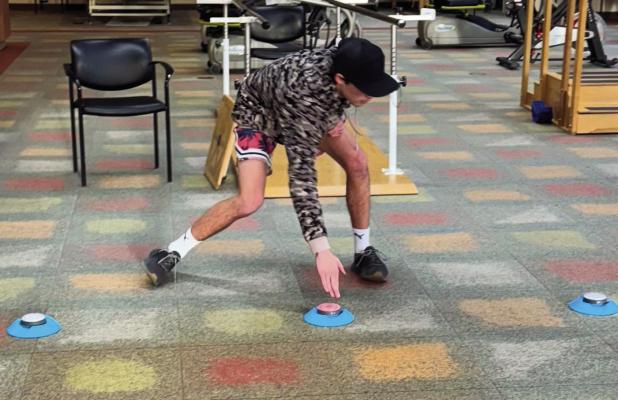 Justin Chancellor actively engages with BlazePods during a physical therapy session, utilizing the innovative tap-and-response system to improve agility, reaction time, and overall rehabilitation progress.