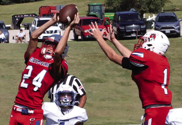 Med Valley’s Isaac Snyder takes a touchdown catch away from teammate Payton Newcomb.