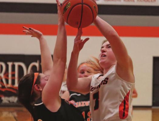 Cambridge’s Brenna Deterding (above) challenges a defender and Emmerie Tomlin (below) knocks down a three at the buzzer.