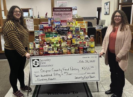Security First Bank staff presenting the Gosper County Food Pantry with a check along with food and personal care item donations.