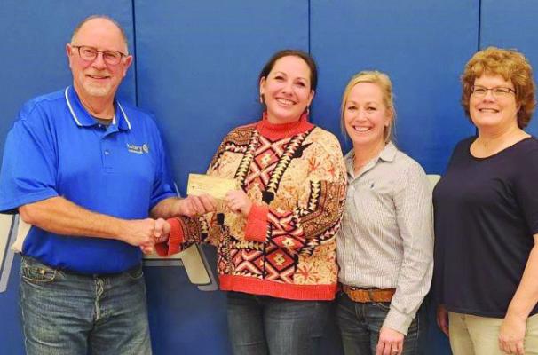 Arapahoe Public Schools BackPack Program director Cassie Helms and Rotarians Reg Warner, Kate Warner and Staci Pick.