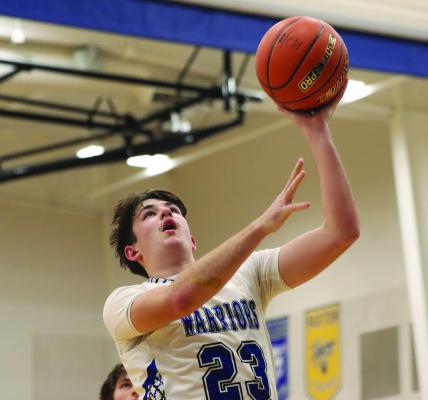 Arapahoe’s Eli Shafer scores at the rim against Cambridge Tuesday.