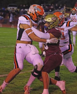 ABOVE: Cambridge’s Dahlton Wood crunches the DCS quarterback for a sack. BELOW: The Trojans’ Derek Trompke lets fly a throw to the end zone.