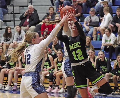 Maywood-Hayes Center’s Blayklee Farr rises for a layup against the defense of Southwest’s Payton Truksa and Atleigh Nelms.