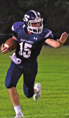 Southwest’s Kaden Day looks to stiff-arm a defender.