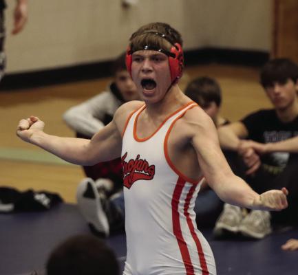 Cambridge’s Hunter Perks celebrates a title Friday.