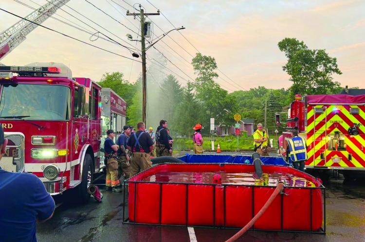 Recently, the Oxford Fire Department held its monthly department drill at Center Fire Station, focusing on water supply operations. Because many areas of town do not have hydrants, firefighters must be prepared to transport water to fire scenes. This training was divided into three stations, each targeting a key part of the process. Crews practiced filling tankers from the nearest available hydrant, transporting water to a portable pond, and then drafting that water to supply an engine or ladder truck 