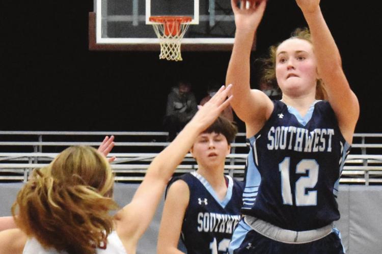 Southwest’s Bailey Truksa pulls up for a jumper in the lane over a closing Hi-Line defender, Kaydee Diefenbaugh.
