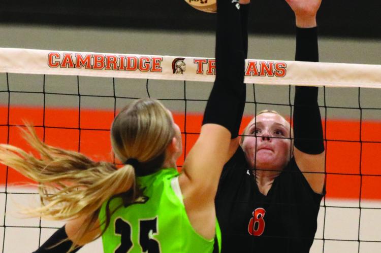 Cambridge’s Joslyn Holtze rises to block an attack from Maywood/ Hayes Center’s Addison Richards.