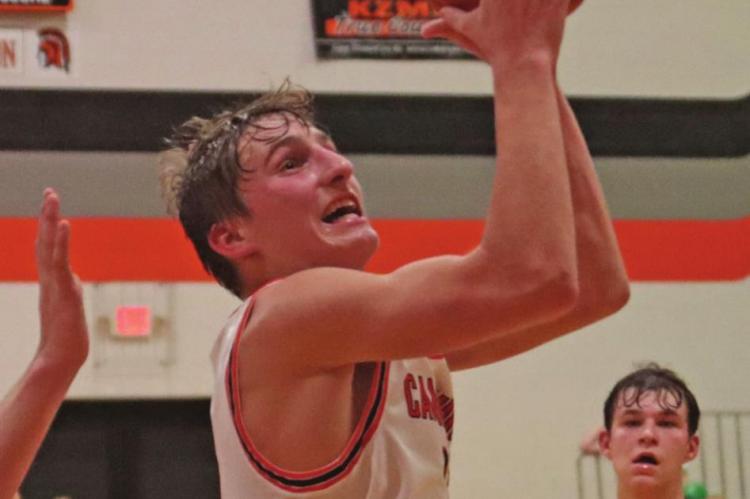 Cambridge's Carson Trompke floats into the lane for a score.