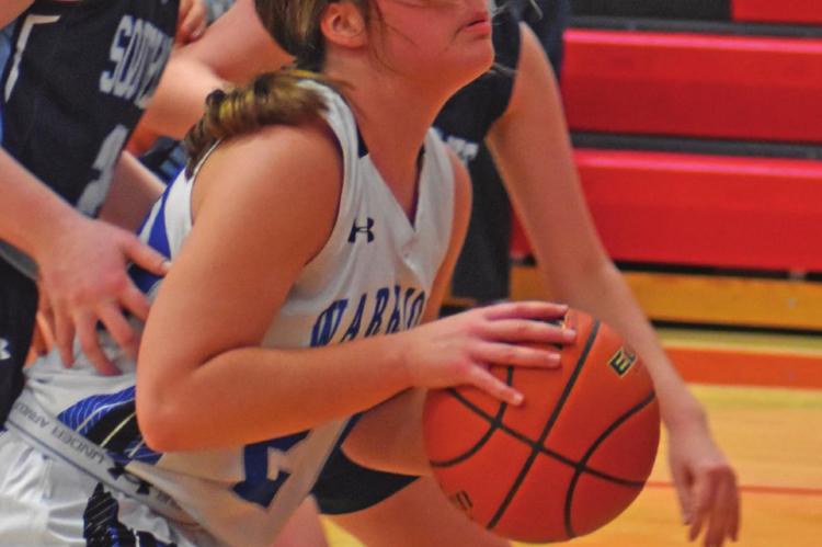 The Warriors’ Tracy Roskop powers up to score inside.